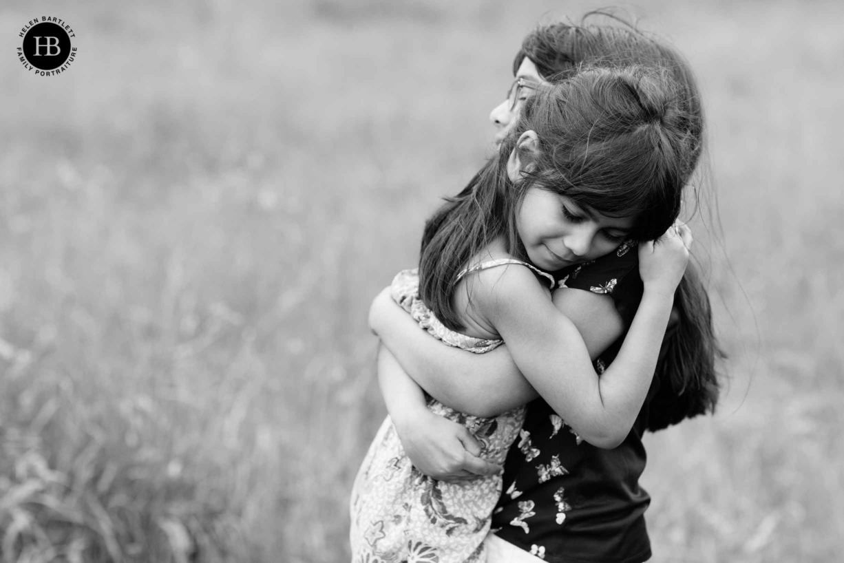 sisters hug on family photography shoot in Islington N1