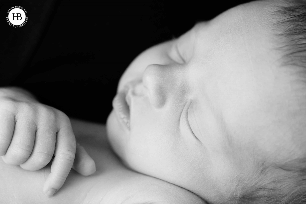 sleeping newborn with dark background, close up shot