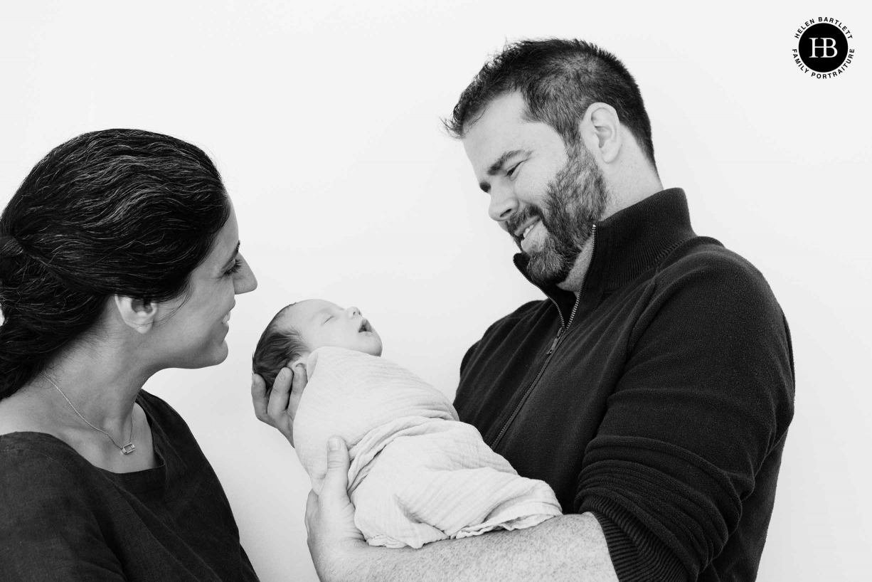 parents smile at sleeping baby son