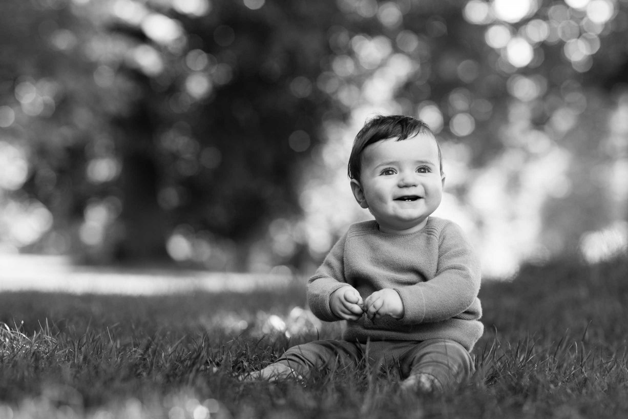 A smiling baby is the clear star in this Chiswick family portrait.