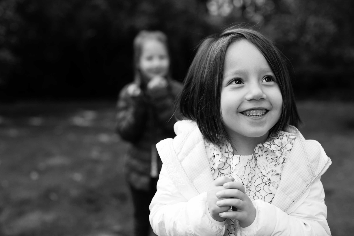 A gleeful smile from this little girl during a Chiswick family photo session by London photographer Helen Bartlett.