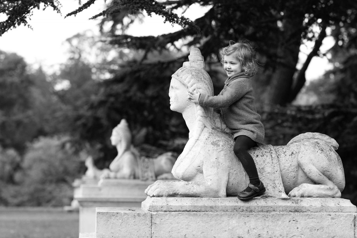 A statue is a horse for this little girl during a Chiswick family portrait session.