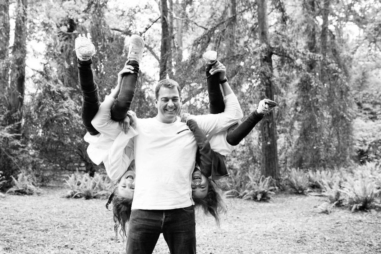 A father and his daughters during a Kew family photo shoot by professional photographer Helen Bartlett.