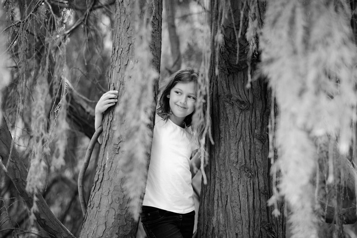 A huge old tree provides a natural backdrop for this family portrait taken in Kew Gardens.