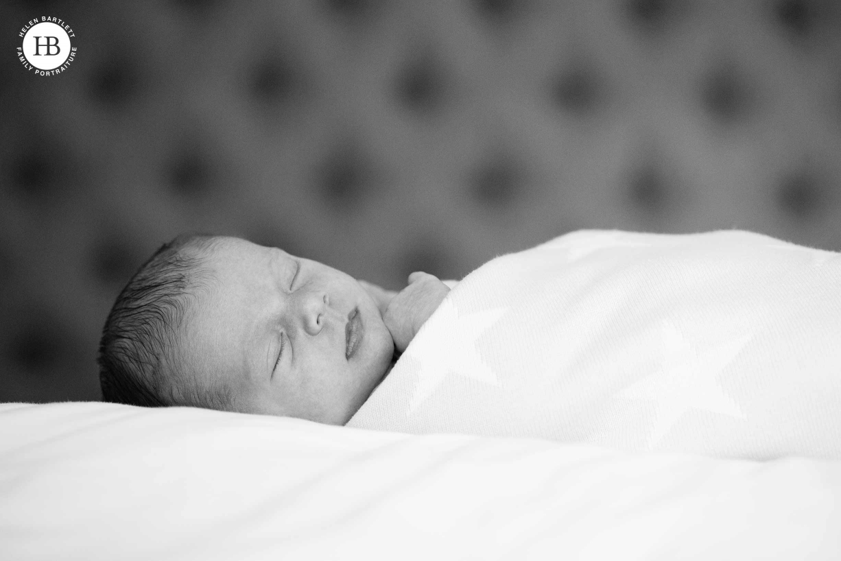 A baby sleeps during a photo session of newborn and sibling photography.