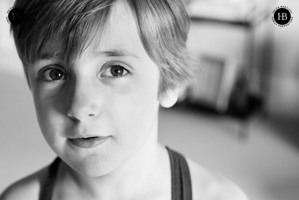 A black and white family photo of a boy in close up.