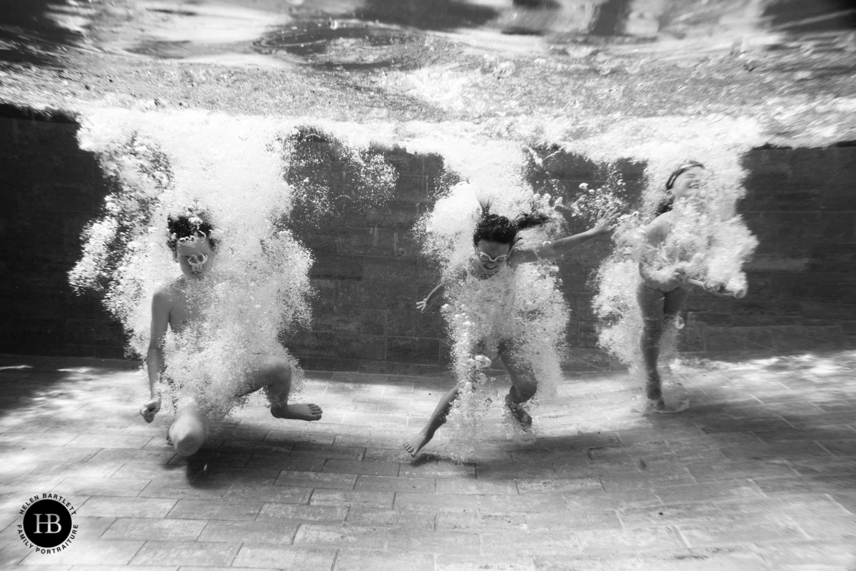 Underwater family photography captures a sense of freedom and adventure, like these boys after they have just jumped into a pool.