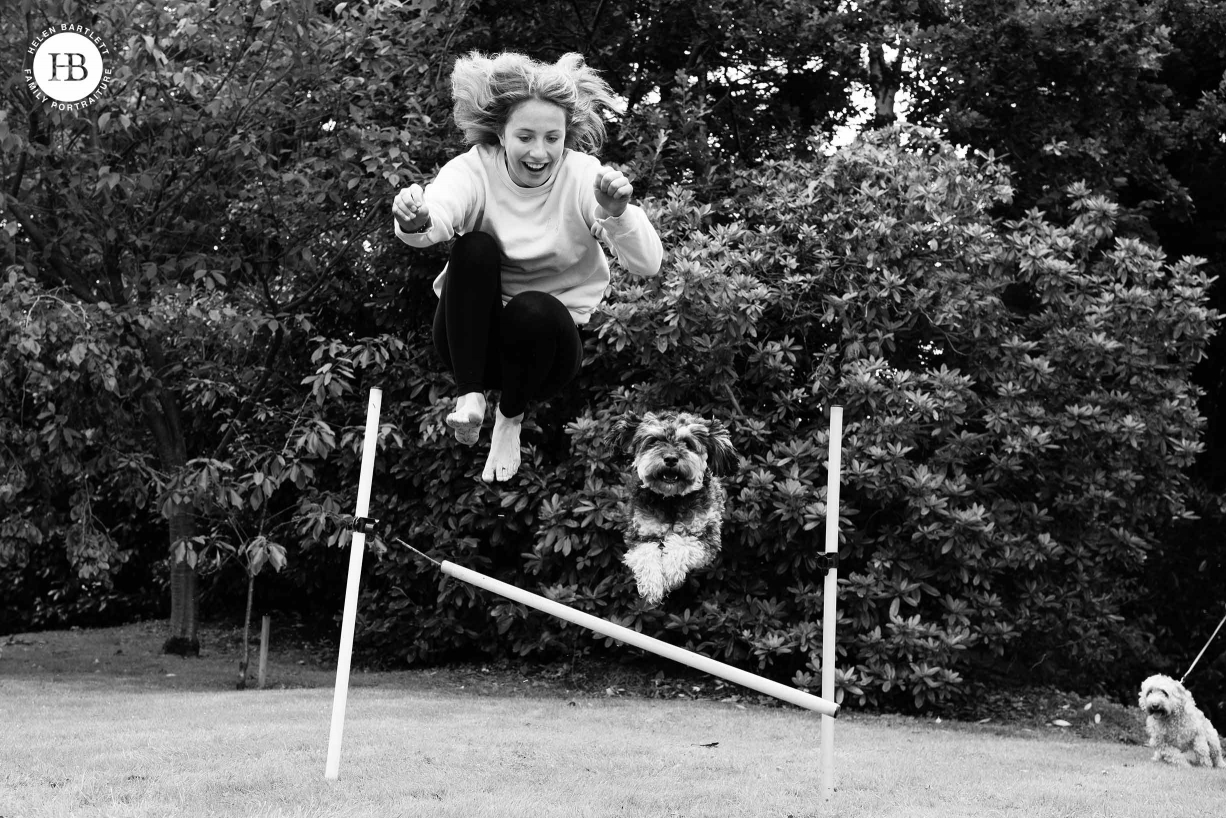 girl and dog jumping on family photo shoot in Sevenoaks