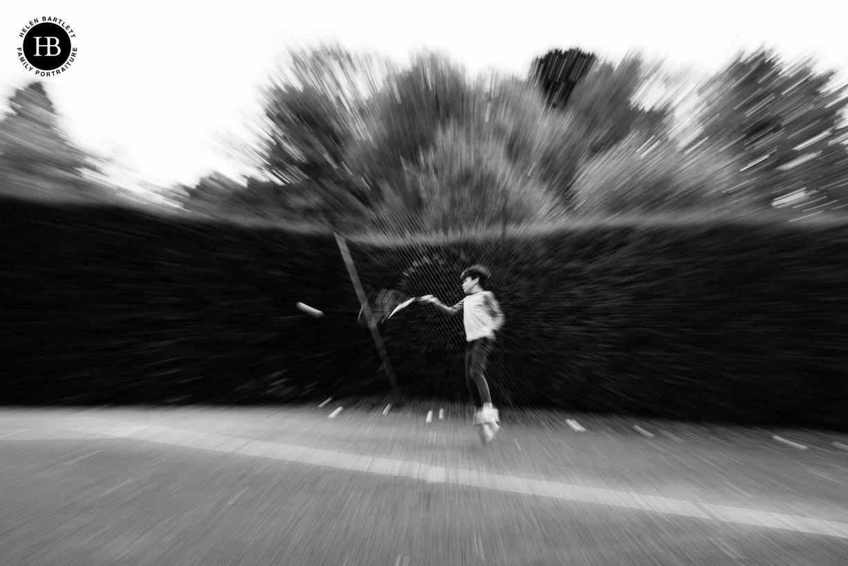 teenage boy photographed playing tennis with zoom burst