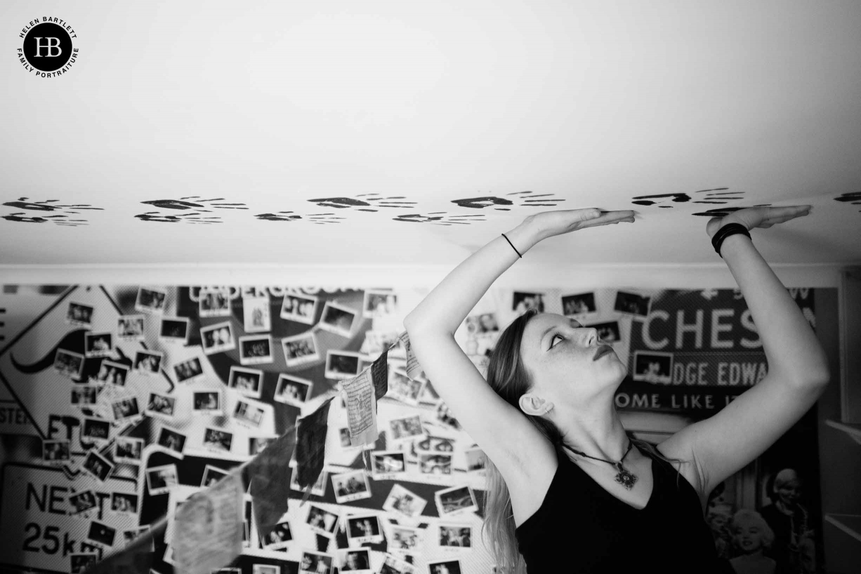 Teenage girl decorates her bedroom ceiling with hand prints