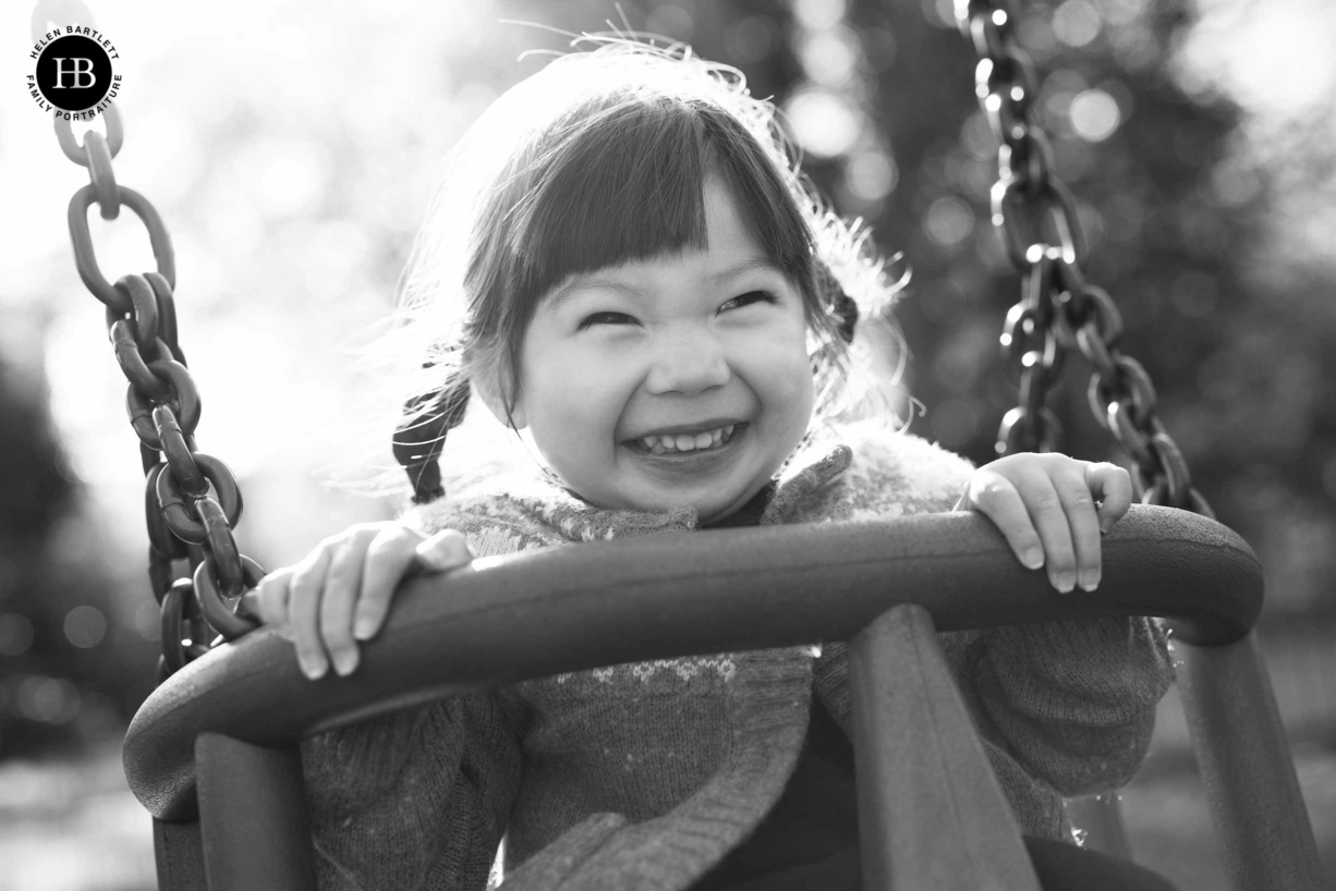 happy child on swings in hampstead