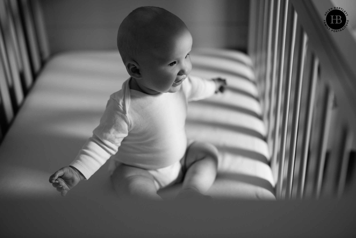 baby-sits-cot-beautiful-shadows-and-light-during-in-home-baby-photo-shoot-islington