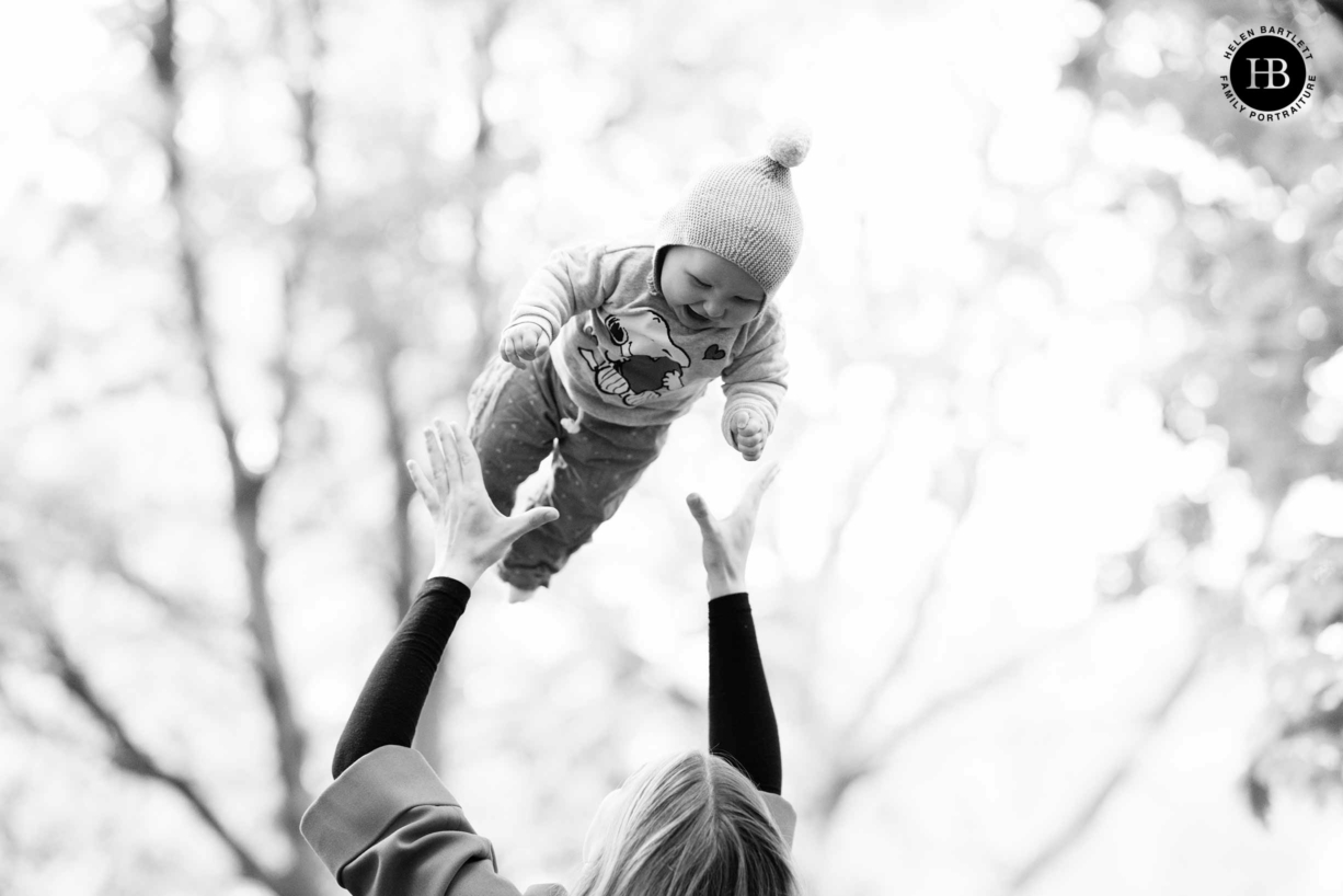 image-by-baby-photographer-in-islington-baby-laughing-while-thrown-in-air