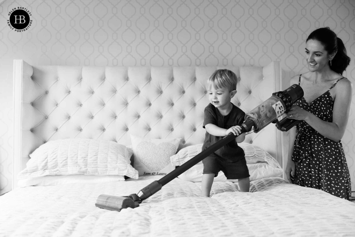 child plays with toy dyson hoover during family photo shoot in clapham