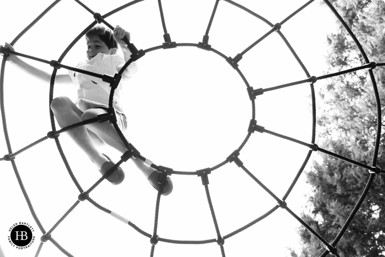 boy climbs on nets in playground west London