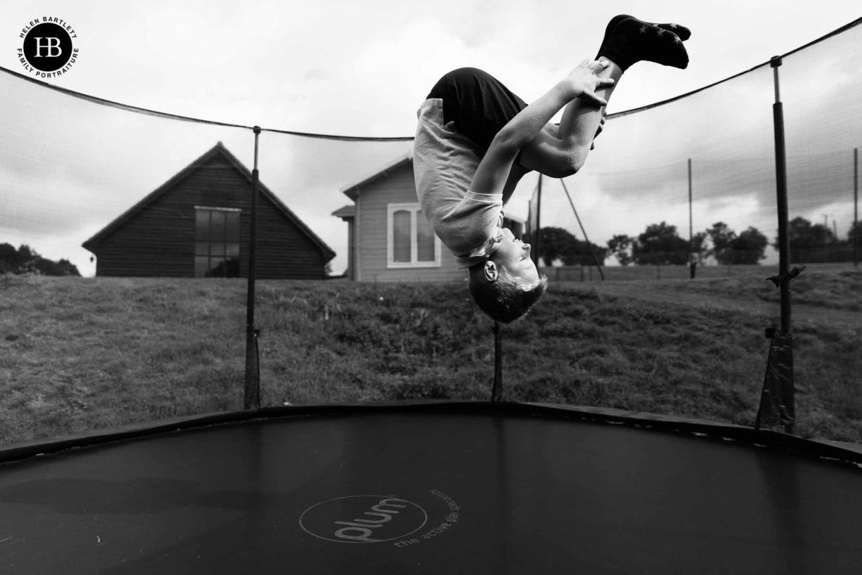 boy plays on trampoline at gladwins farm in suffolk