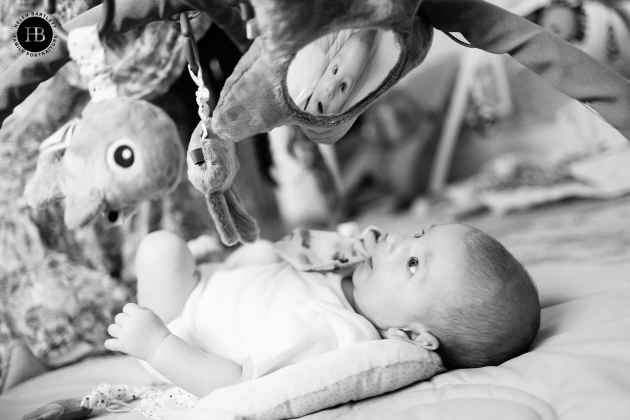 baby-looks-self-mirror-on-playmat