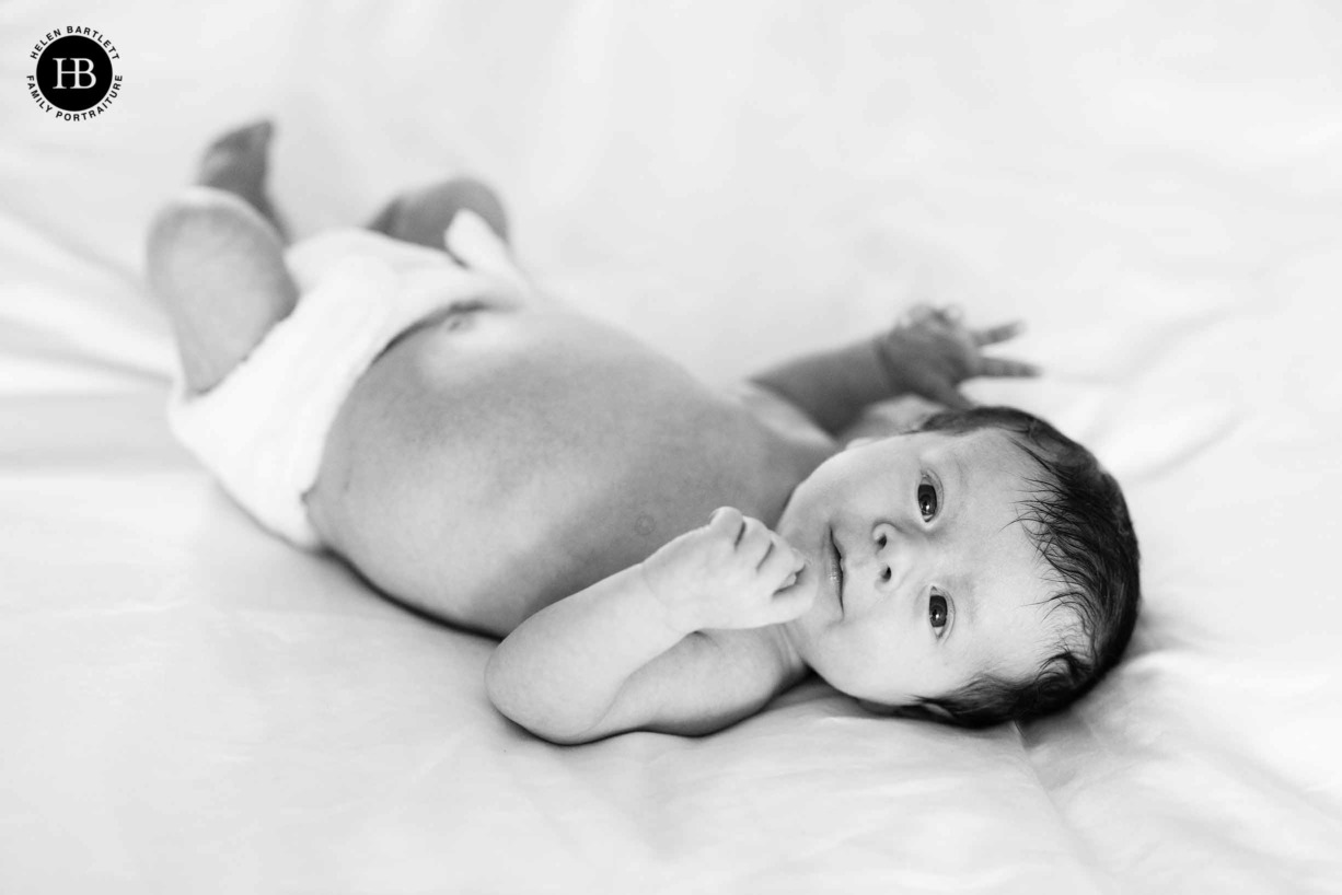 black and white portrait of newborn baby on a bed