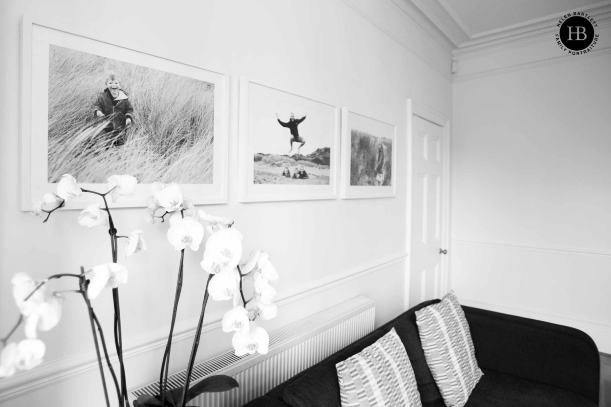 three framed family photos displayed on the living room wall