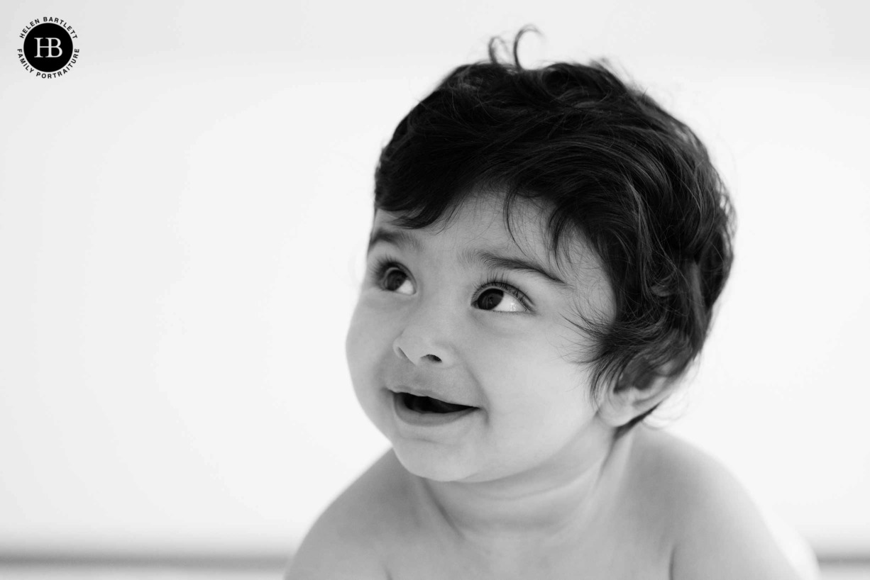 head and shoulders portrait of happy baby in paddington