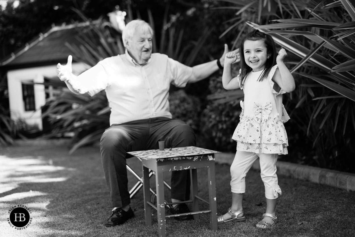 little girl wins at snakes and ladders with her grandfather