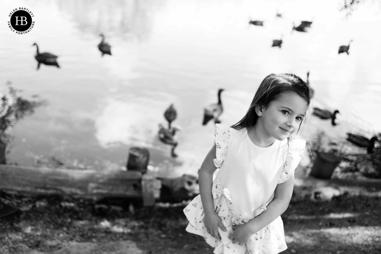 little girl feeds the ducks at weald country park