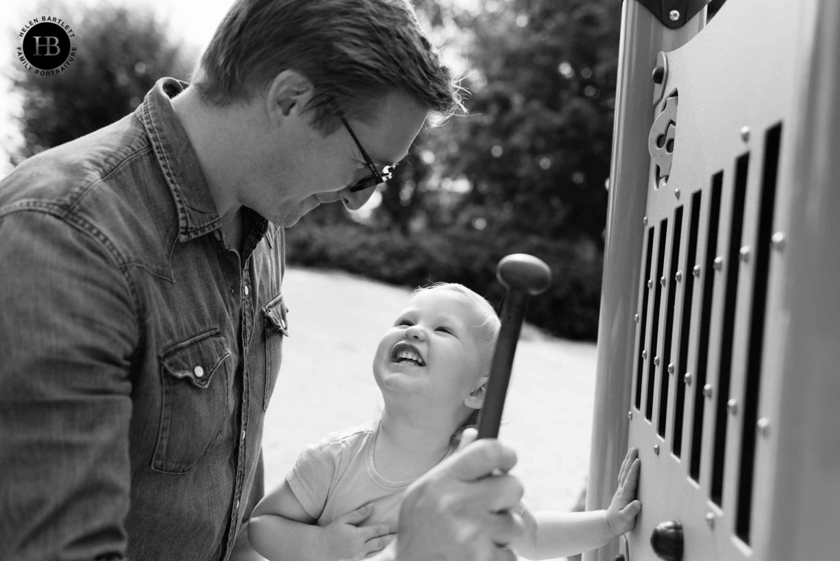 dad and little girl play in playground