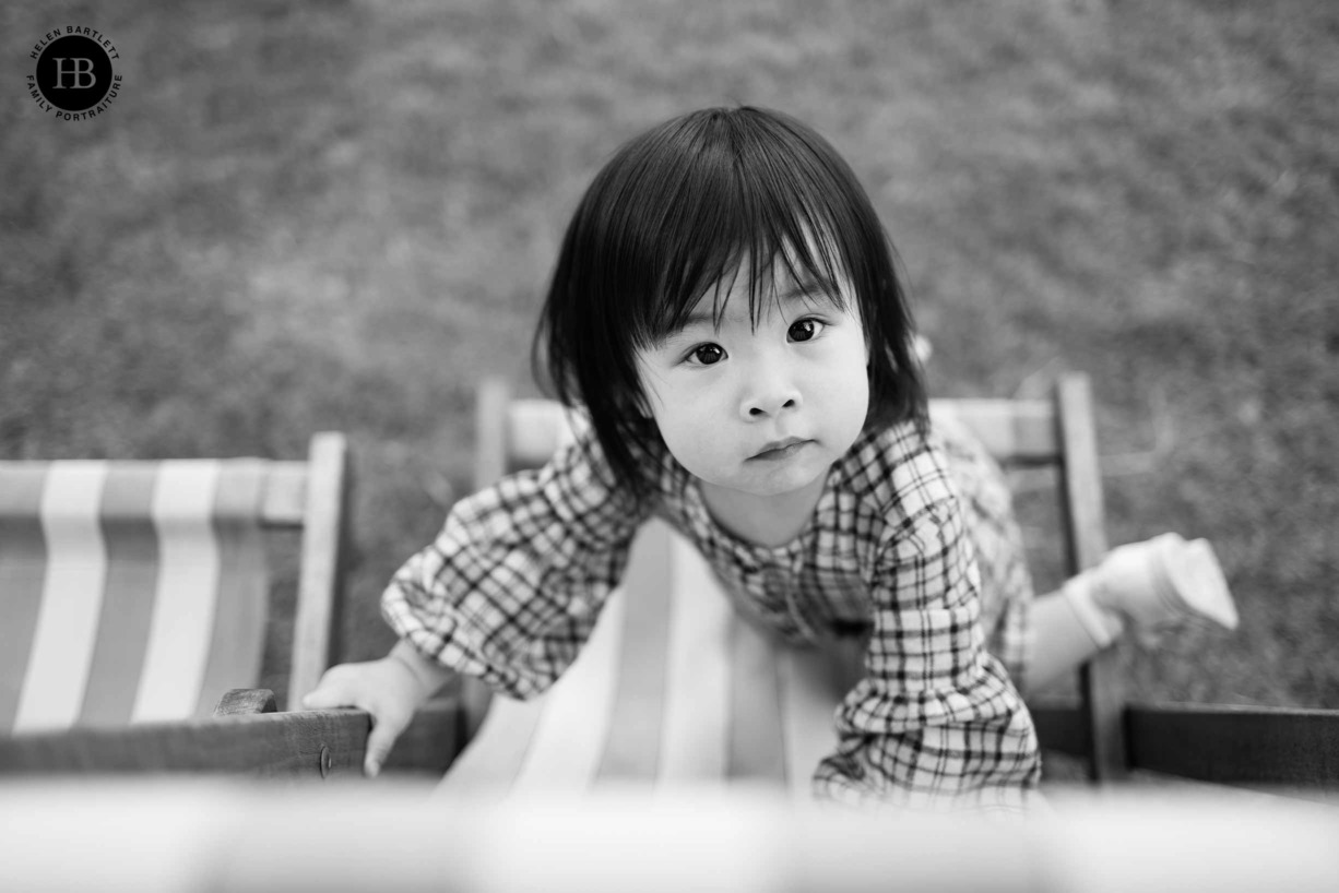 Toddler plays on deck chair during London landmark photo shoot