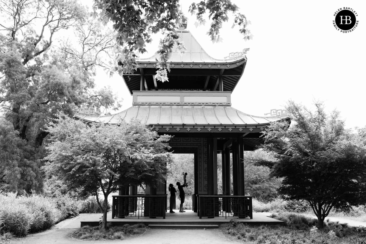 silhouetted family portrait in pagoda in victoria park in hackney