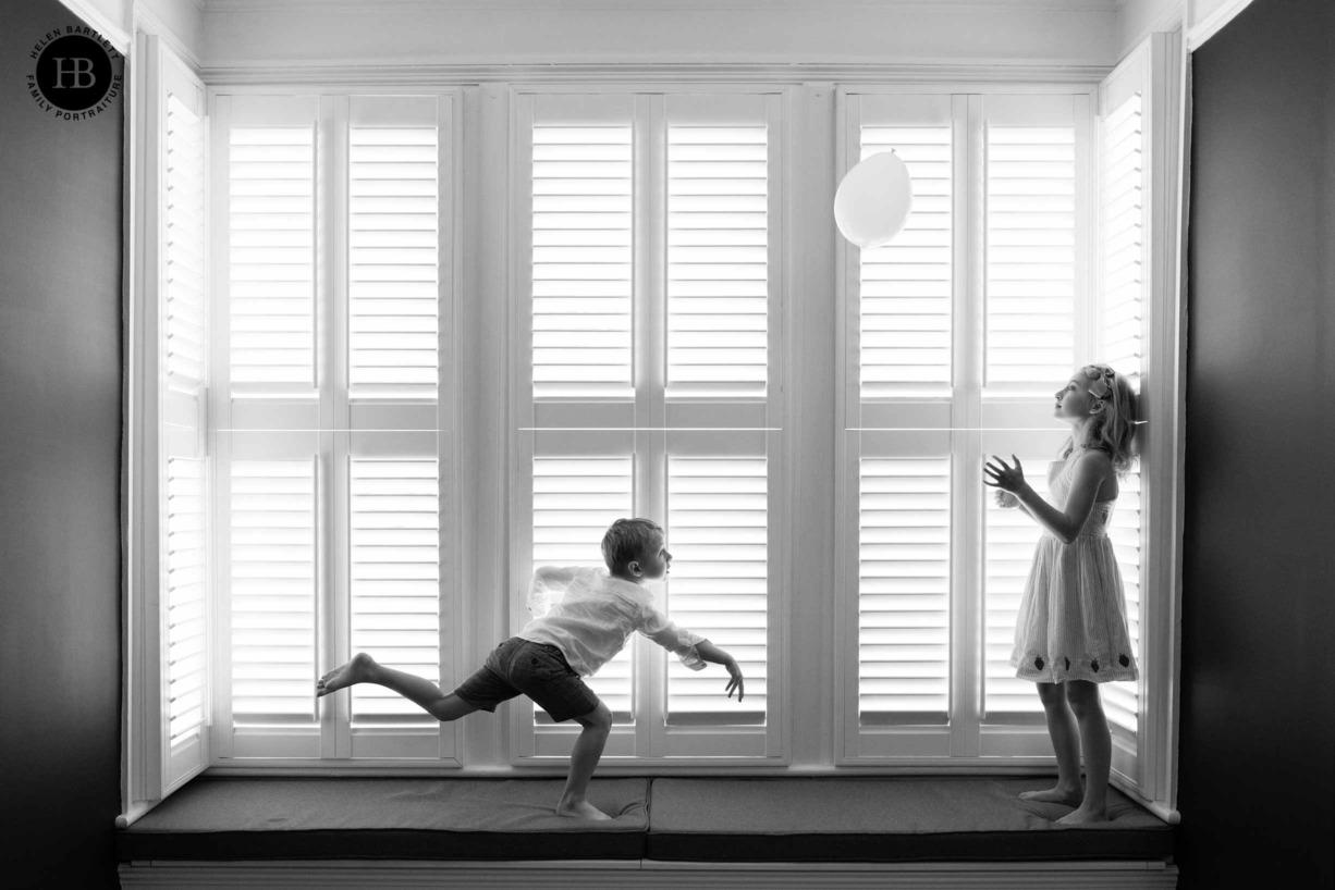 children-play-with-balloon-on-window-seat-winchmore-hill