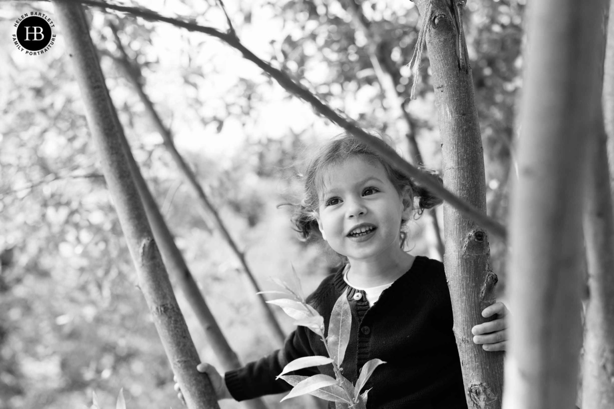 little-girl-climbing-tree-black-and-white-portrait