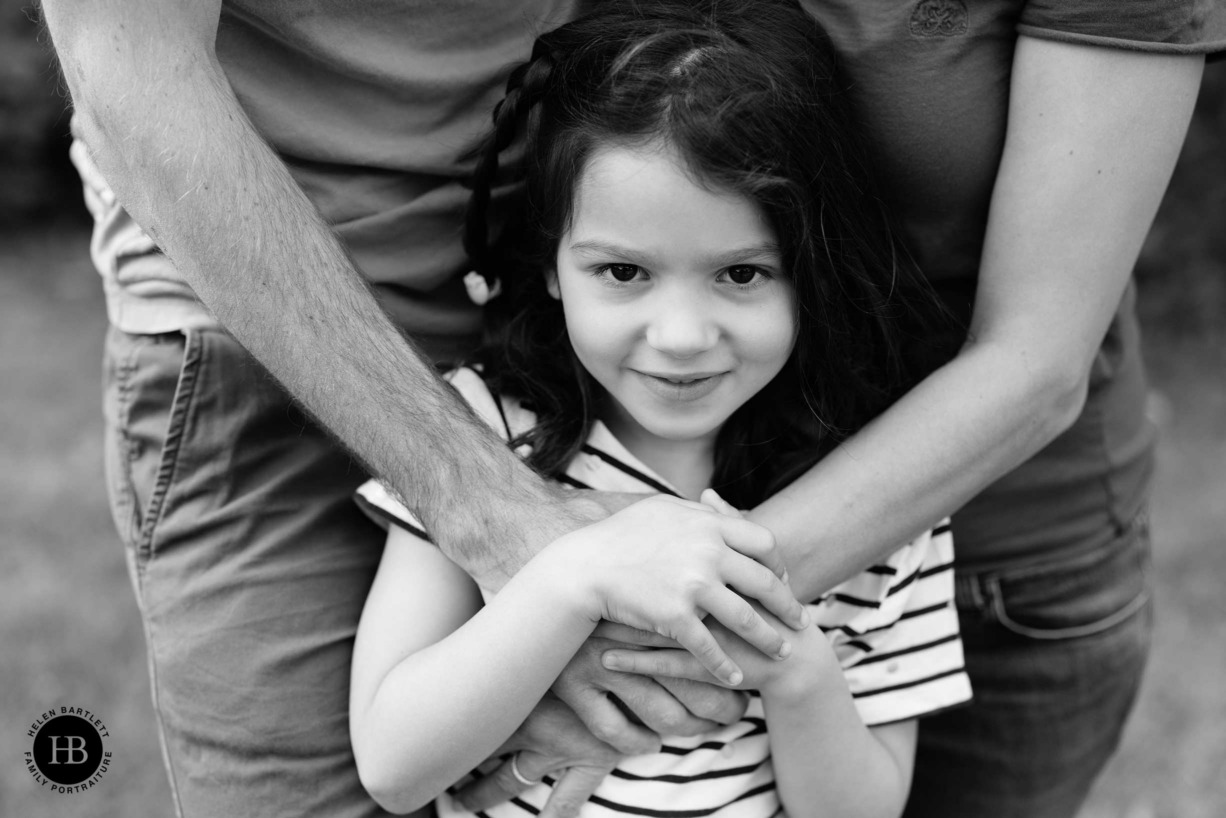 portrait-girl-with-parents-hands