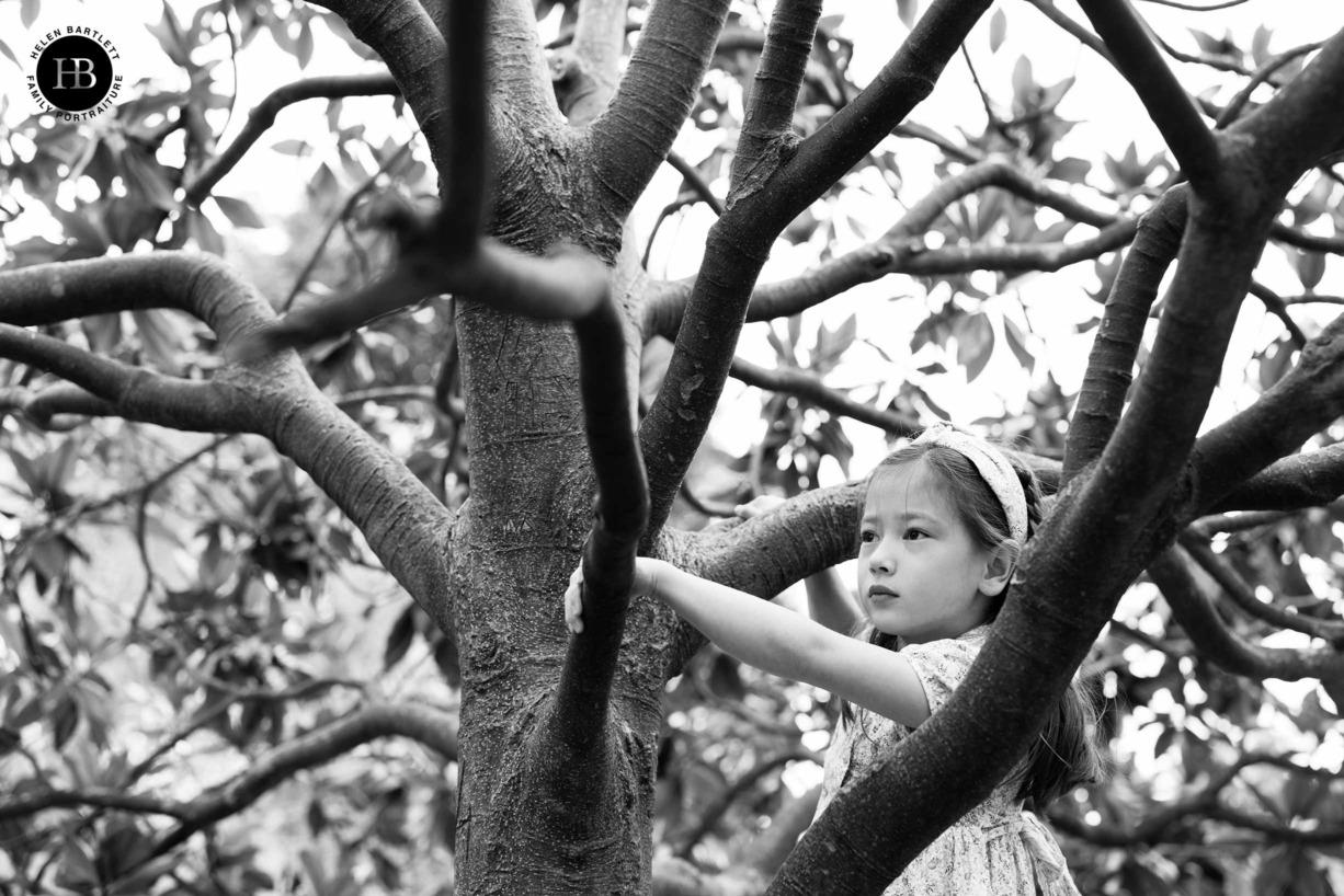 black-and-white-portrait-girl-climbing-tree