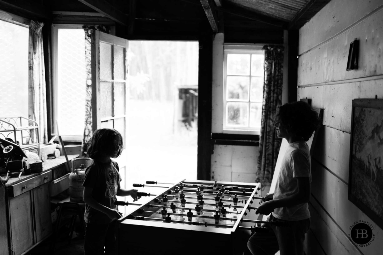 boys-play-table-football-in-shed