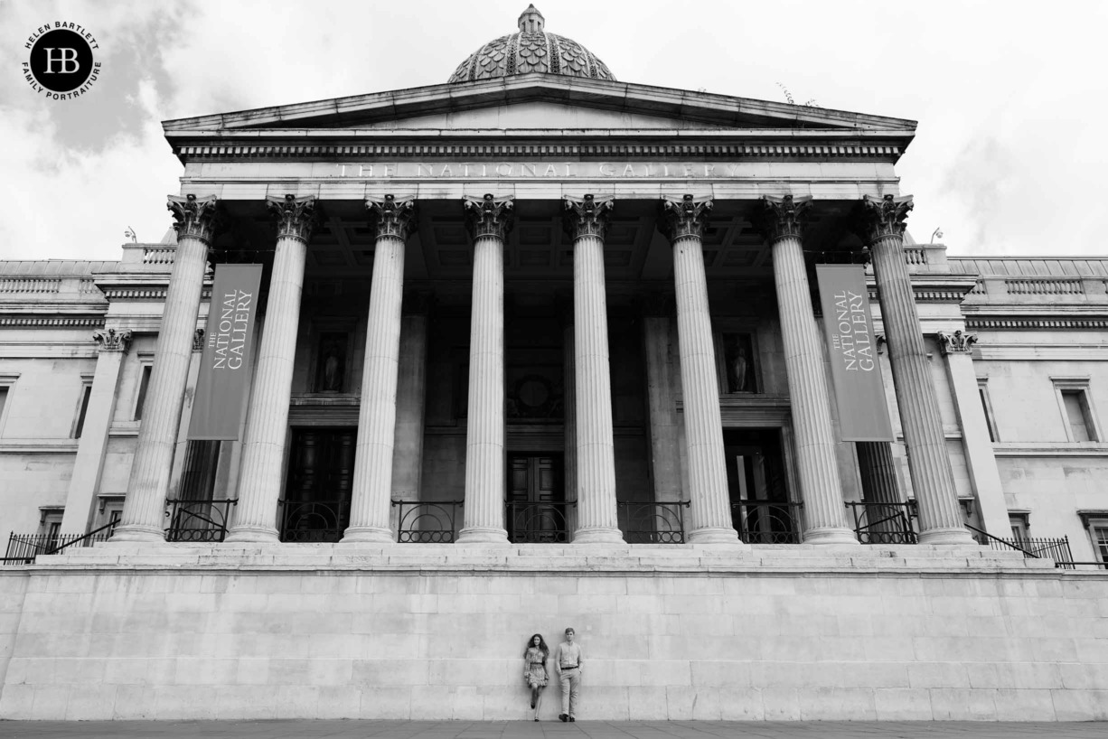 Teenagers pose in front of London's national gallery showing the whole building for a sense of scale