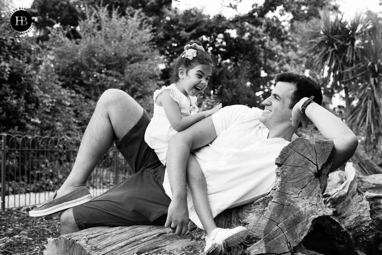 little-girl-and-dad-laugh-together-family-photo