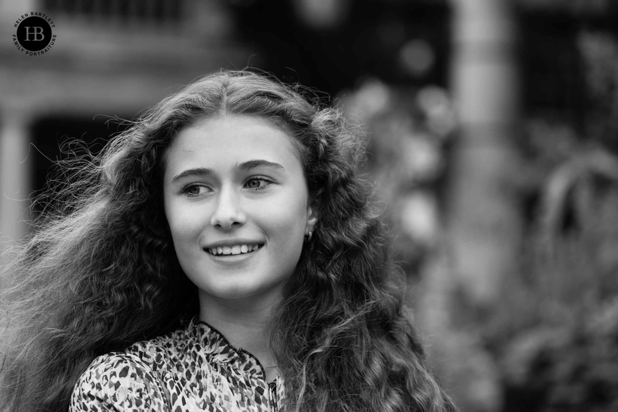 teenage girl laughs with her hair flying in London's Covent Garden