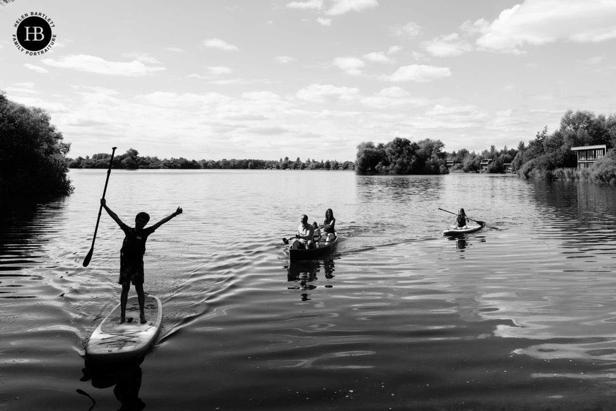 family-paddle-boarding-in-black-and-white