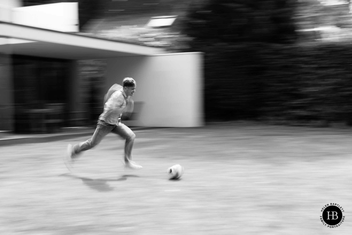 teenager-running-with-football-panning-to-show-speed