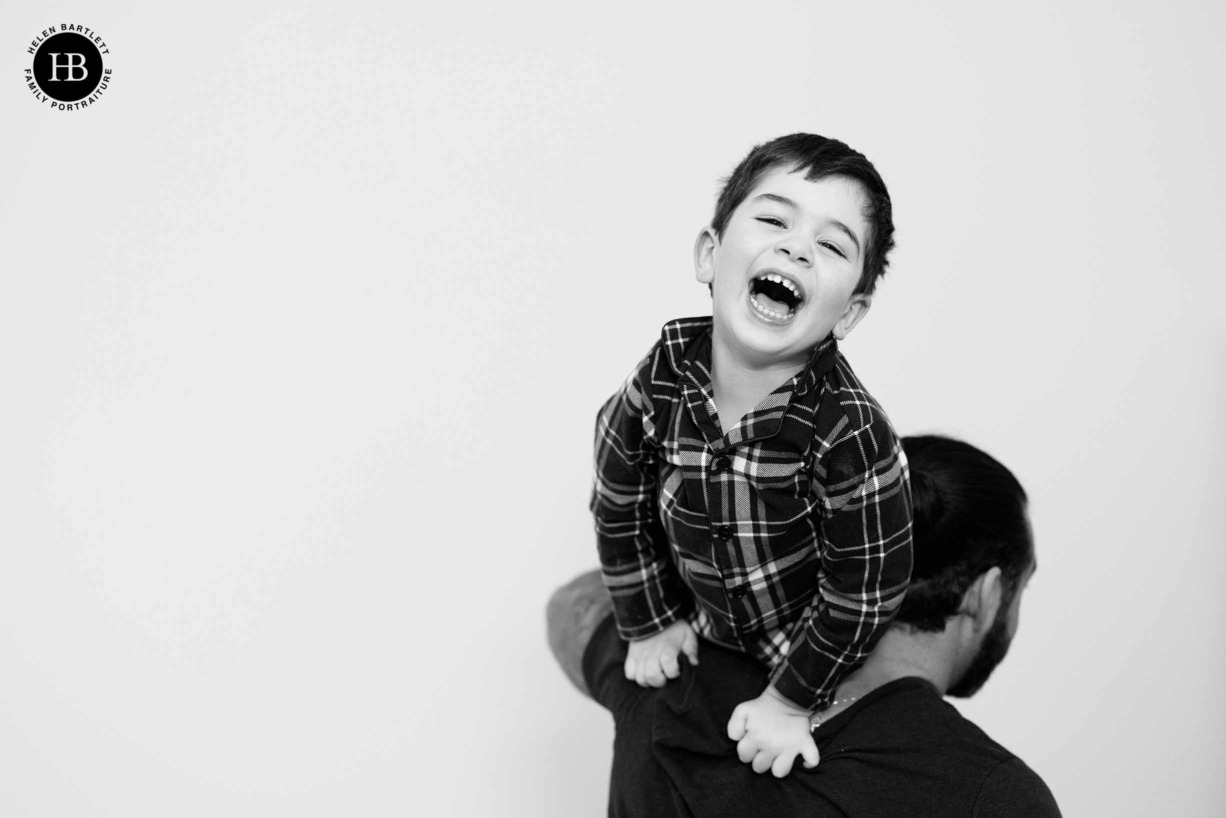 dad-carries-laughing-son-family-photo-shoot-chiswick