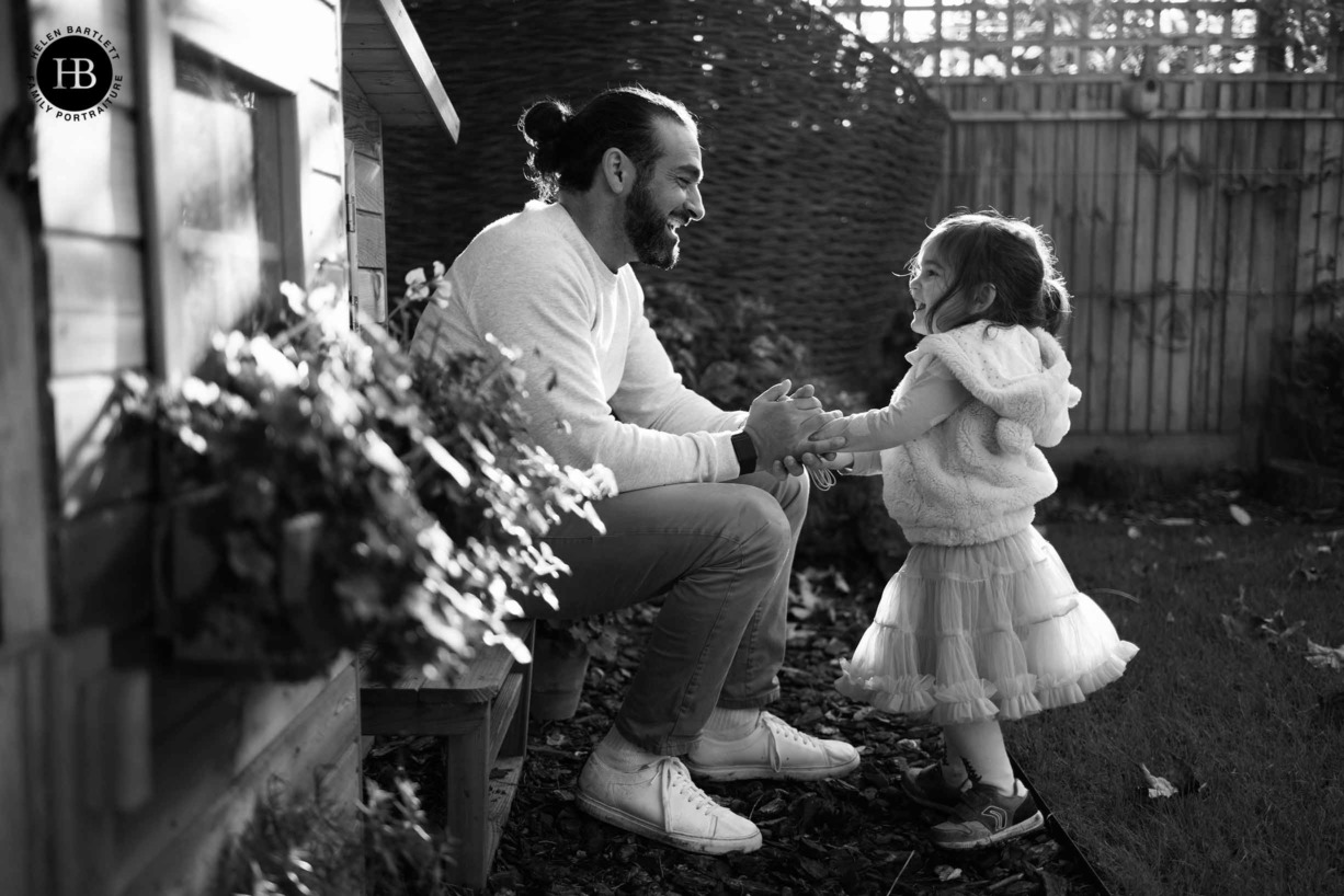 dad-daughter-laugh-together-back-garden-chiswick