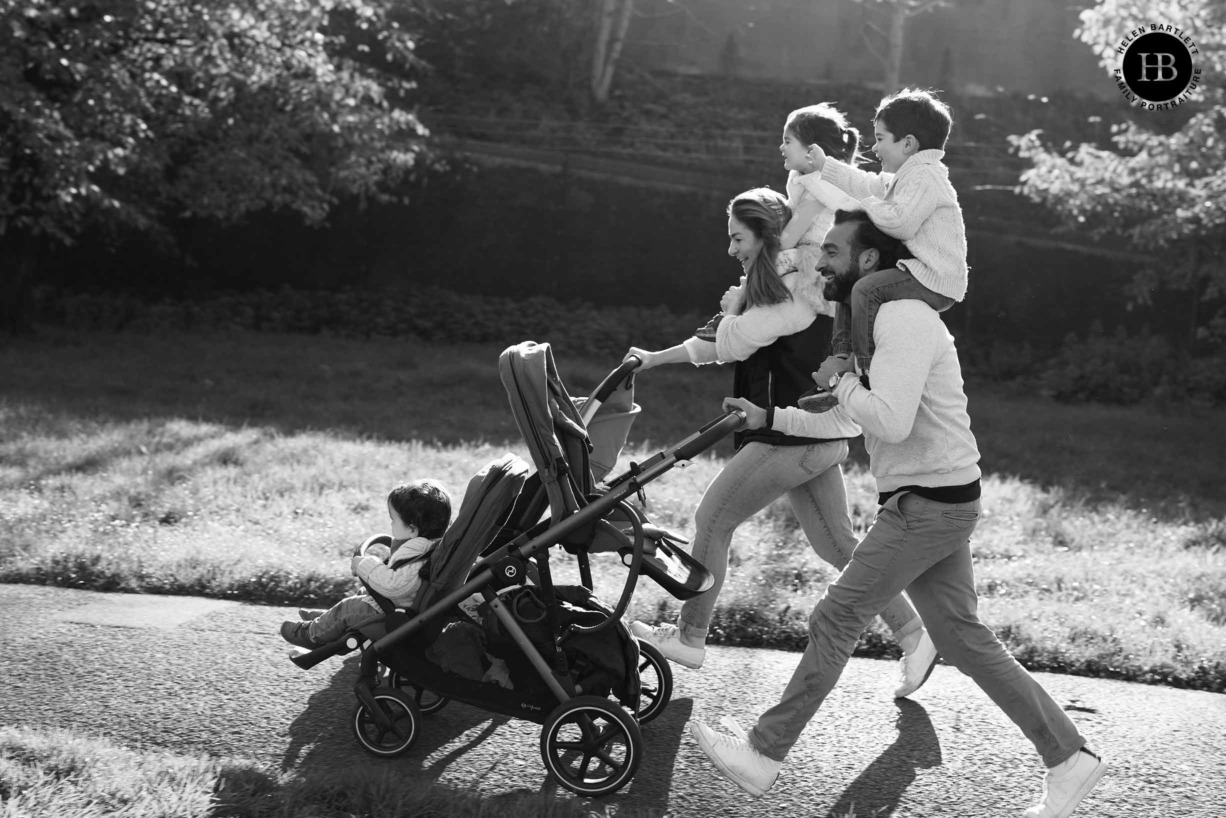 family-race-with-children-on-shoulders-pushing-buggies