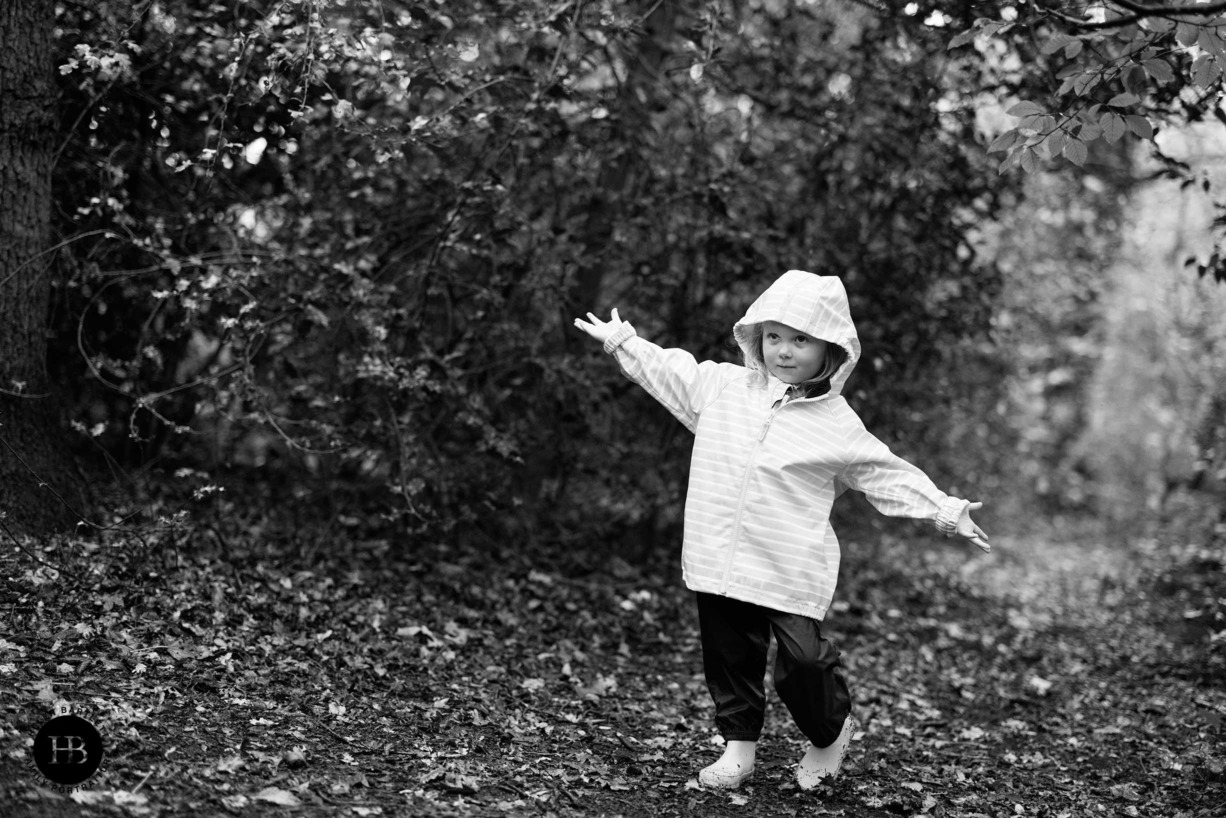 little-girl-plays-in-woods-on-rainy-day