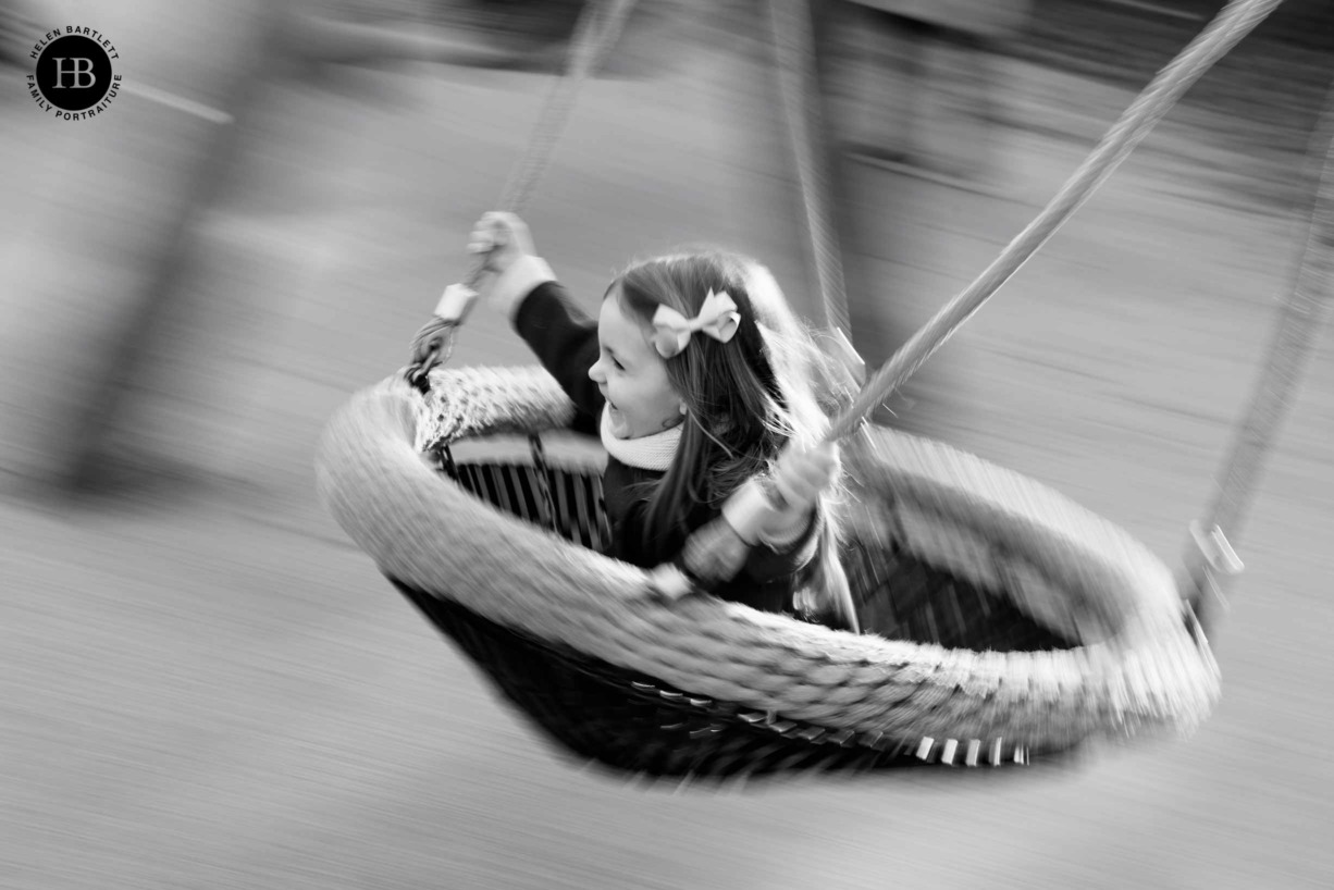 panning-shot-of-girl-on-swing-monochrome