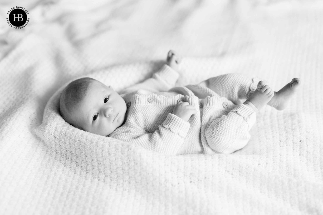 newborn-photographed-parents-bed-monochrome