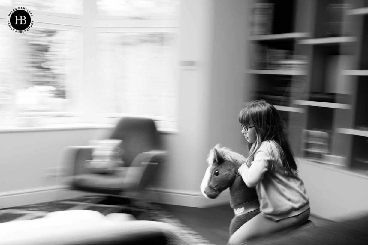 child-rides-rocking-horse-fast-around-living-room