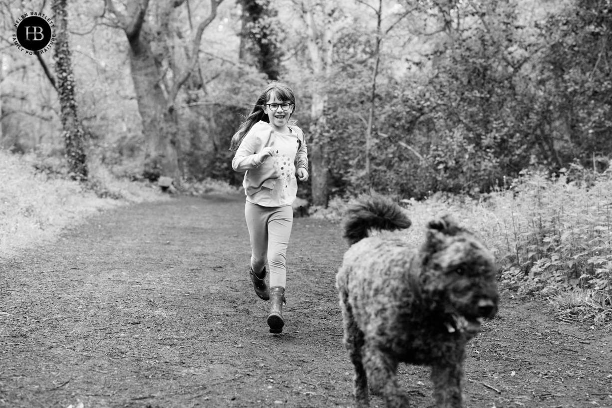 girl-runs-in-wood-with-dog