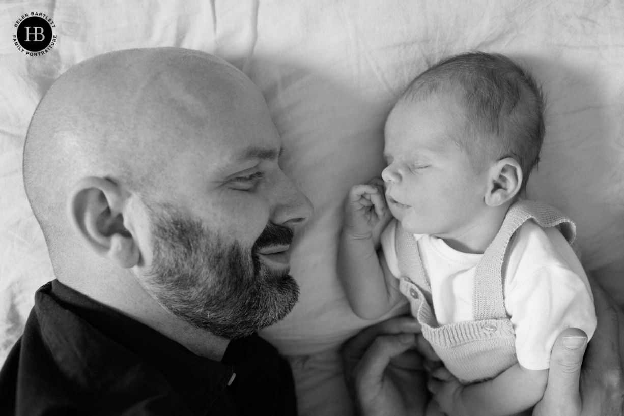 dad-and-newborn-son-face-to-face-smiling