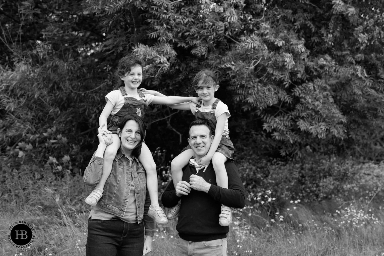 family-photo-twin-girls-on-parents-shoulders