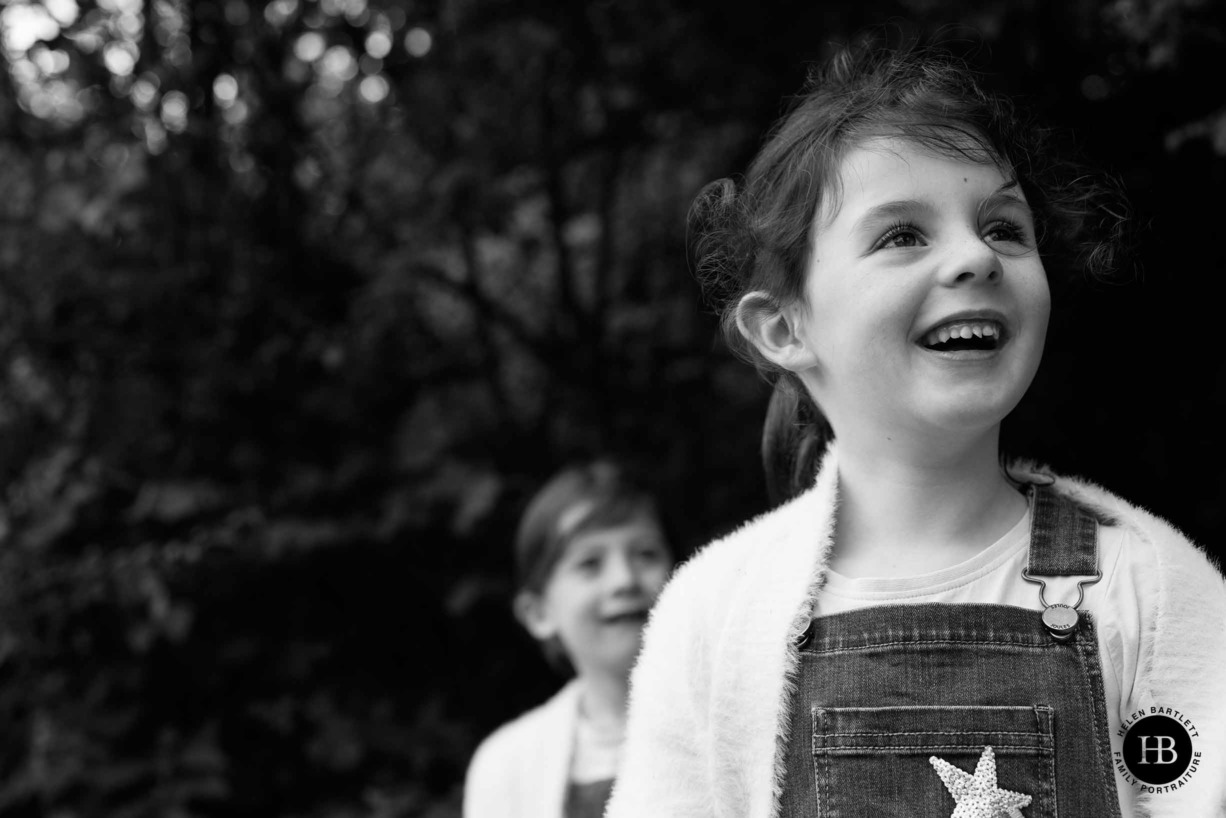 little-girl-laughs-at-camera-monochrome-portrait